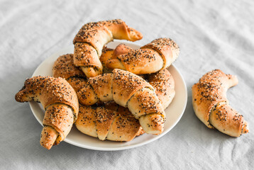 Poppy seeds croissants on a grey background. Delicious pastries for breakfast, snack