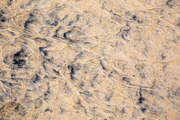 black sand on the beach in Thailand