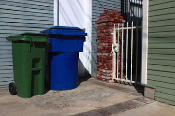 Garbage bins for different types of garbage at the gate of a private house. Garbage collection and sorting of garbage.