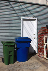 Garbage bins for different types of garbage at the gate of a private house. Garbage collection and sorting of garbage.