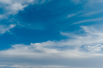 White clouds stretched across the blue sky on a warm sunny day