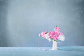 bouquet of pink and white peonies  on background old wall