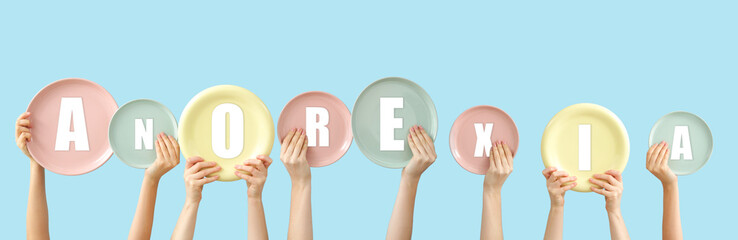 Female hands with plates on color background. Concept of anorexia