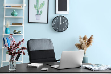 Modern workplace with laptop in room