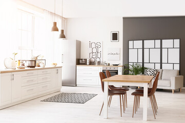 Stylish interior of modern kitchen with dining table