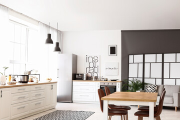 Stylish interior of modern kitchen with dining table