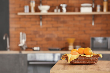 Basket with fresh fruits on kitchen table