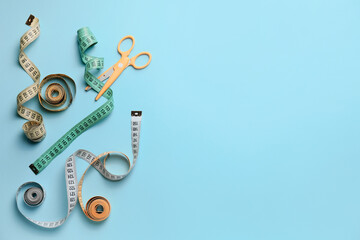 Scissors with measuring tapes on color background