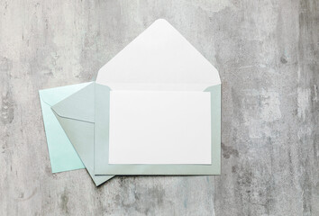 Blank card with envelopes on grey background
