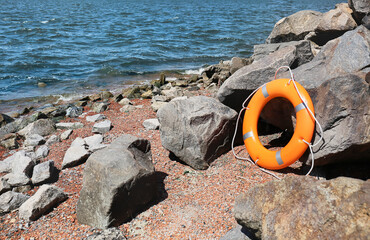 Bright lifebuoy ring on coast
