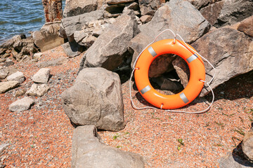 Bright lifebuoy ring on coast