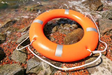 Bright lifebuoy ring on coast