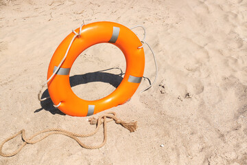 Bright lifebuoy ring on beach