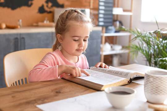 Little Girl Reading Bible At Home