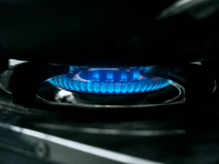 Blurred background of blue flame burning by kitchen gas cooker.