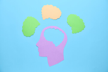 Paper human head and brains on color background