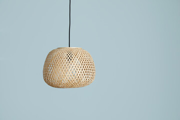 Modern lamp hanging against color wall