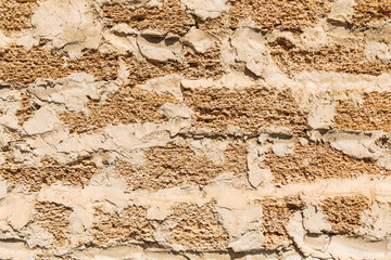 Rough texture of a brick wall made of shells