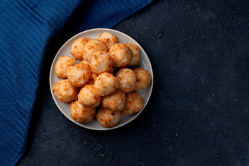 Energy balls with coconut and nuts. A wholesome homemade dessert. Fitness Diet. Dark background