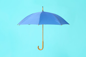 Stylish umbrella on color background