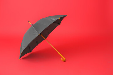 Stylish umbrella on color background