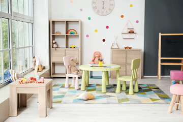 Stylish interior of modern playroom in kindergarten