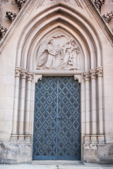 Fototapeta na wymiar Old church textured door with stone arch facade
