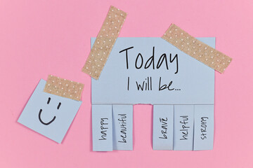 Motivational concept with blue tear-off stub note with text 'Today I will be...' and words 'happy,...