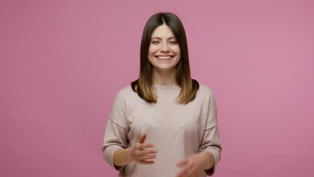 Hearing loss, deaf disability. Friendly girl communicating with voiceless gesture, making fingers shape asking nonverbal phrase Hi let's learn sign language. studio shot isolated on pink background