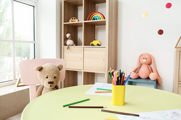 Stylish interior of modern playroom in kindergarten