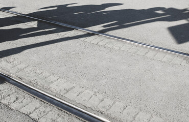 human shadows on tram rails
