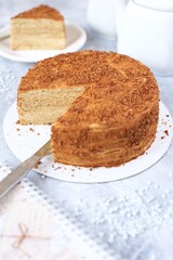 honey cake on light table with tea set