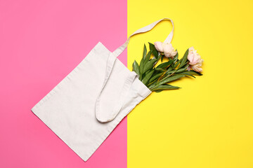 Eco bag with flowers on color background