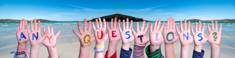 Children Hands Building Colorful Word Any Questions. Ocean And Beach As Background