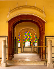 Jaipur, Rajasthan, India; Feb, 2020 : colourful tinted glass design around windows at the Hawa Mahal, Jaipur, Rajasthan, India