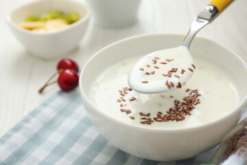 Bowl of yogurt and flax seeds on table