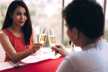 Asian lover couple man and woman hand hold a champagne drink on valentine