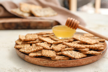 Plate with cereal cookies and honey on white background