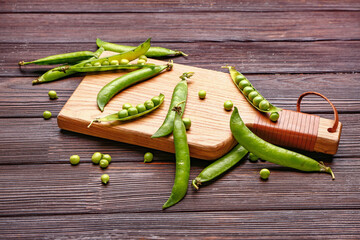 Board with tasty fresh peas on table
