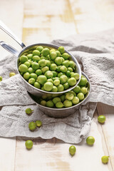 Bowls with tasty fresh peas on table