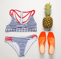 Gordijnen Swimsuit with shoes and pineapple on white background © Pixel-Shot