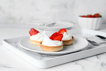 Plate with tasty tartlets on tray