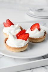 Plate with tasty tartlets on tray