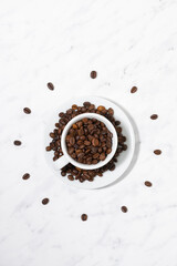 conceptual photo of a cup with coffee beans in the form of a dial, vertical