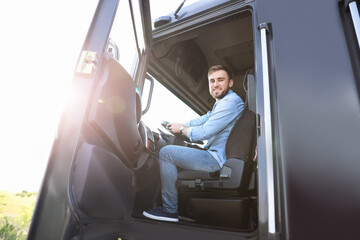 Male driver in cabin of big truck