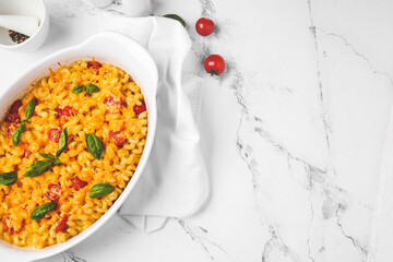 Tasty baked pasta in dish on white background