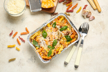 Tasty baked pasta in dish on light background