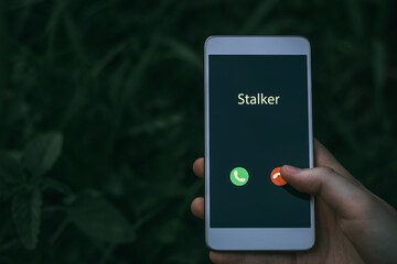 Stalker caller. A woman holds a phone in his hand and thinks to end the call. Incoming from an unknown number. Incognito or anonymous, scammer or stranger