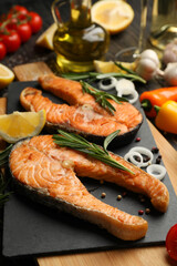 Composition with tasty grilled salmon on wooden background, close up