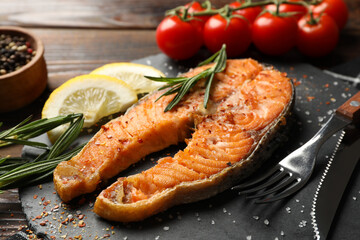 Composition with tasty grilled salmon on wooden background, close up
